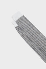 Close-up of the ribbed cuff on Bresciani Michele socks, in a white and jeans melange texture.