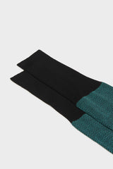 Close-up of the herringbone pattern and the high cuff on Bresciani Giulio socks, in a black water color.