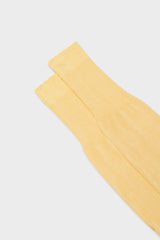 Close-up of the ribbed cuff on Bresciani Lorenzo socks, in a solid grapefruit color.