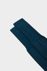 Close-up of the pindots pattern on the cuff of Bresciani Fabio socks, in a red peacock color.