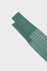 Close-up of the geometric micro-pattern and cuff on Bresciani Nicola socks, in a mint color.
